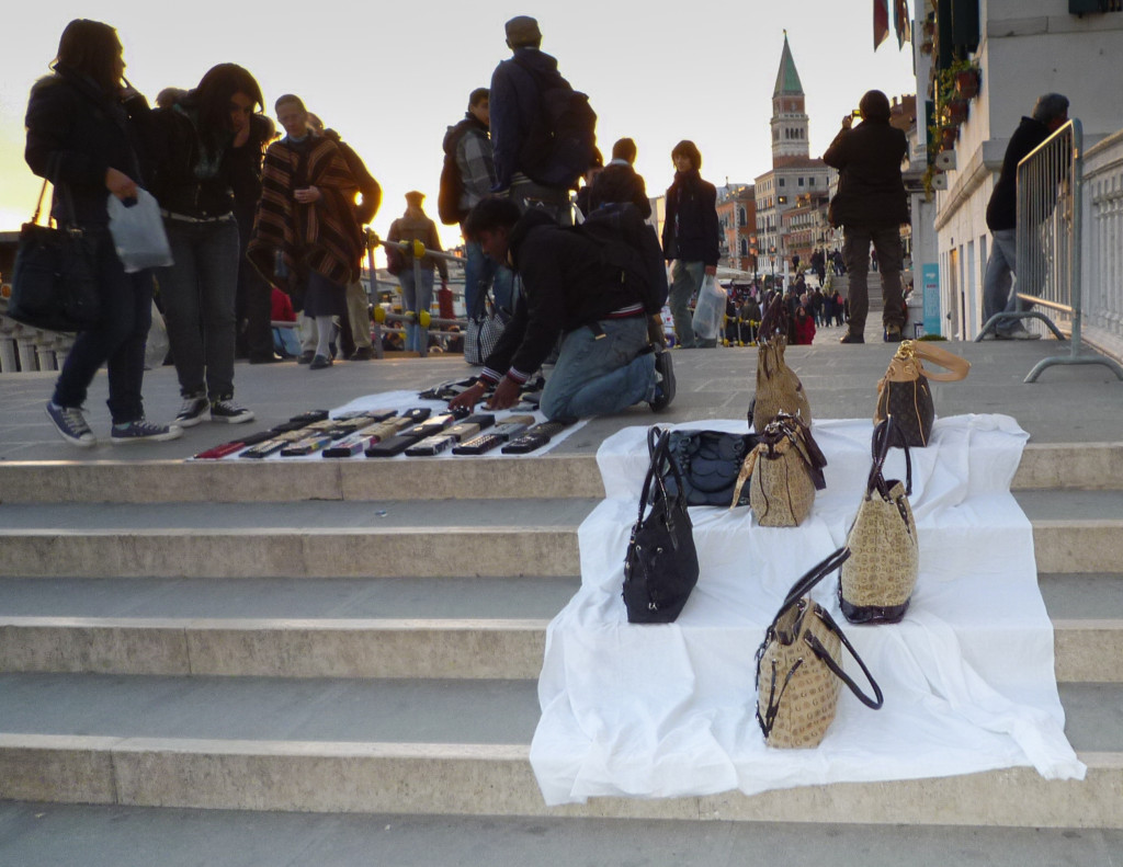 A white cloth is laid over the stone steps with bags on it.