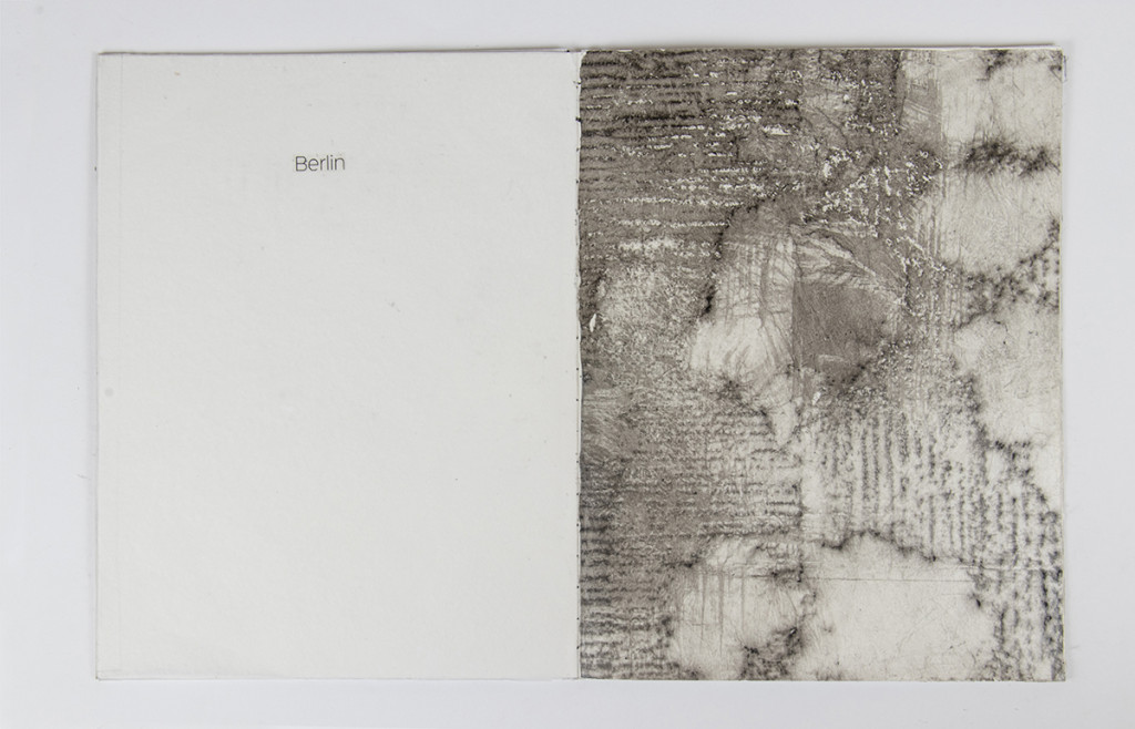 Open artist book with a frottage covering the right side.