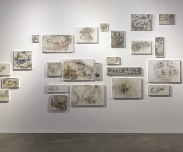 Art Installation on the wall consisting of many small canvases with prints of marks on walls in public spaces. Nadia Kaabi-Linke, Archive of Tunis Banalities.