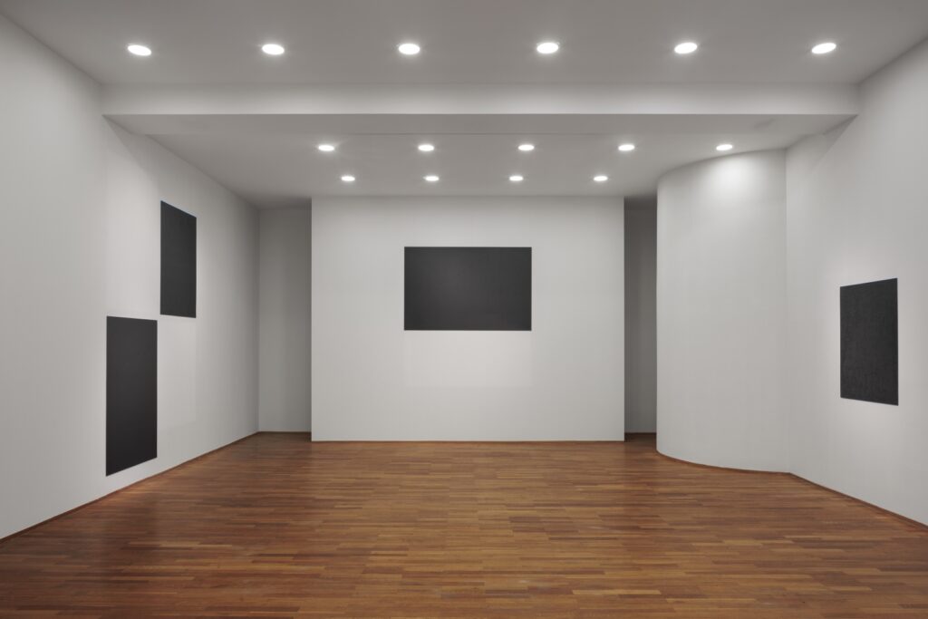 installation features a series of paired white and black rectangles reflecting cultural loss