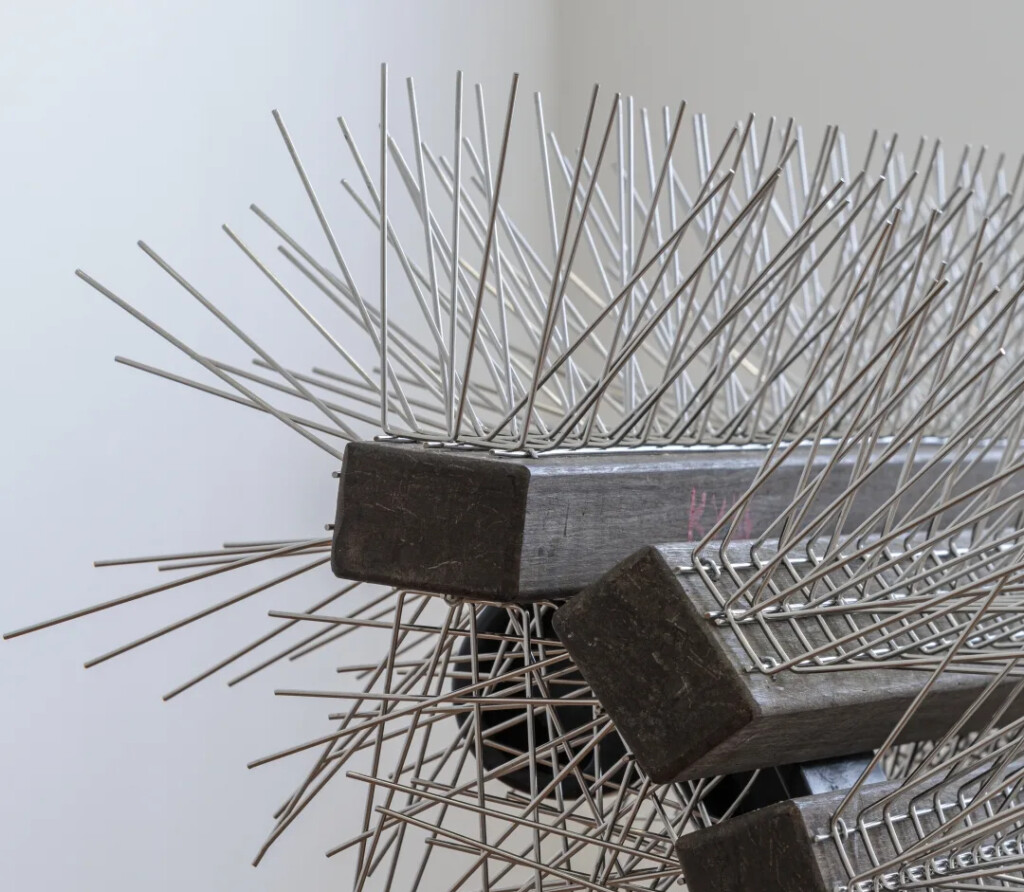 Detail of a Bench covered with bird spikes.