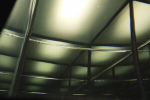Lines are reflected within a glass cube filled with water