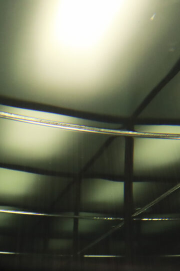 Lines are reflected within a glass cube filled with water. Nadia Kaabi-Linke, Squeezed in Infinity I.
