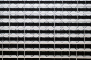 Close up of an artwork, pictures with a slightly changing black and white image aligned close to each other ( Close Up) / Squeezed in Infinity II, 2023, Nadia Kaabi-Linke, Series of 514 photographs