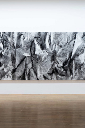 Abstract black and white artwork featuring textured swirls and shapes, displayed on a white wall / Kula:Cuts, Nadia Kaabi-Linke 2017