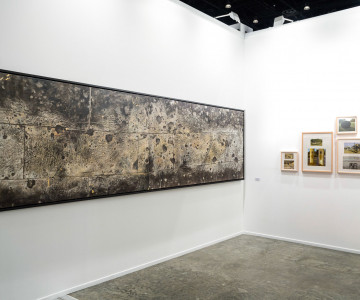 Installation view, off the Wall, 2008, a weathered Berlin façade with bullet-marked ornaments, symbolizing war's remnants and resilience amid change, transferred onto canvas by the artist Nadia Kaabi-Linke