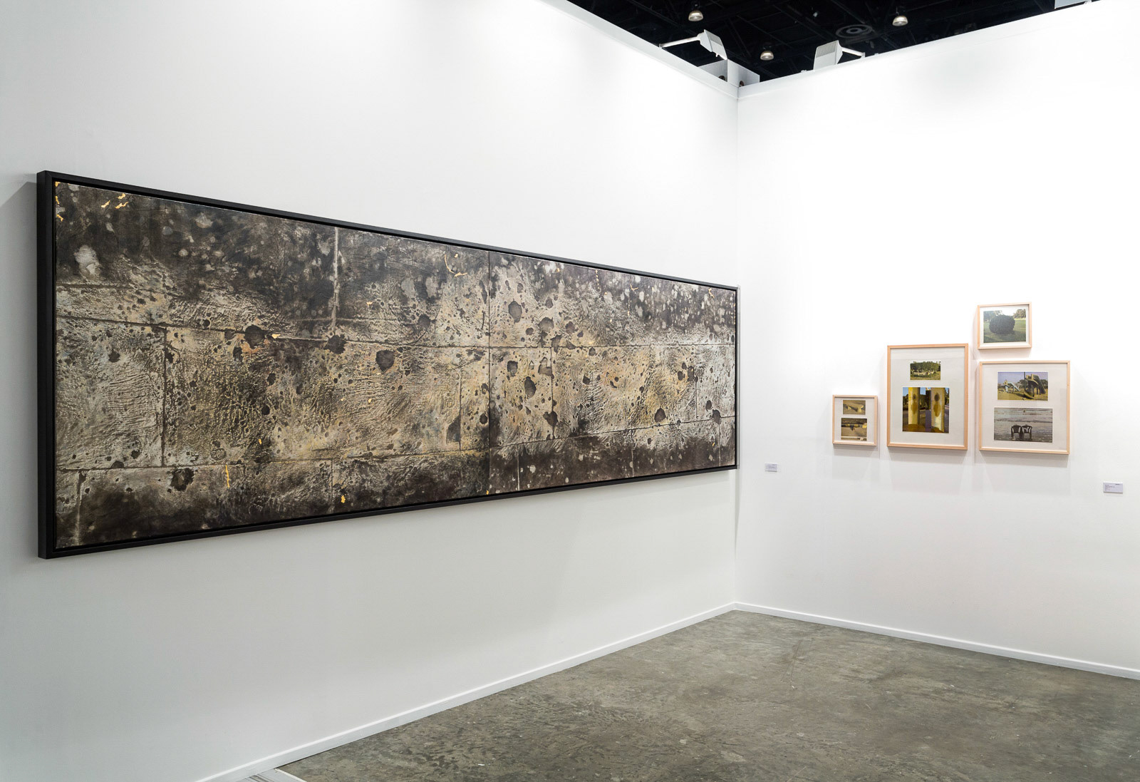 Installation view, off the Wall, 2008, a weathered Berlin façade with bullet-marked ornaments, symbolizing war's remnants and resilience amid change, transferred onto canvas by the artist Nadia Kaabi-Linke