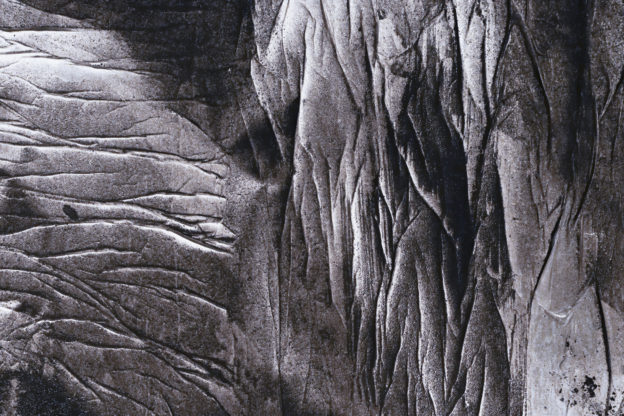 Close of a black and white painting with lignite grains on canvas.