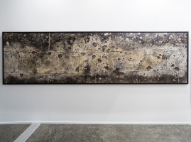 Installation view, off the Wall, 2008, a weathered Berlin façade with bullet-marked ornaments, symbolizing war's remnants and resilience amid change, transferred onto canvas by the artist Nadia Kaabi-Linke