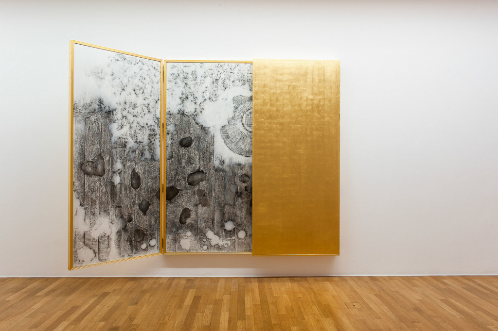 Half open triptych outside coated in gold leaf, inside showing transferred traces of World War One.