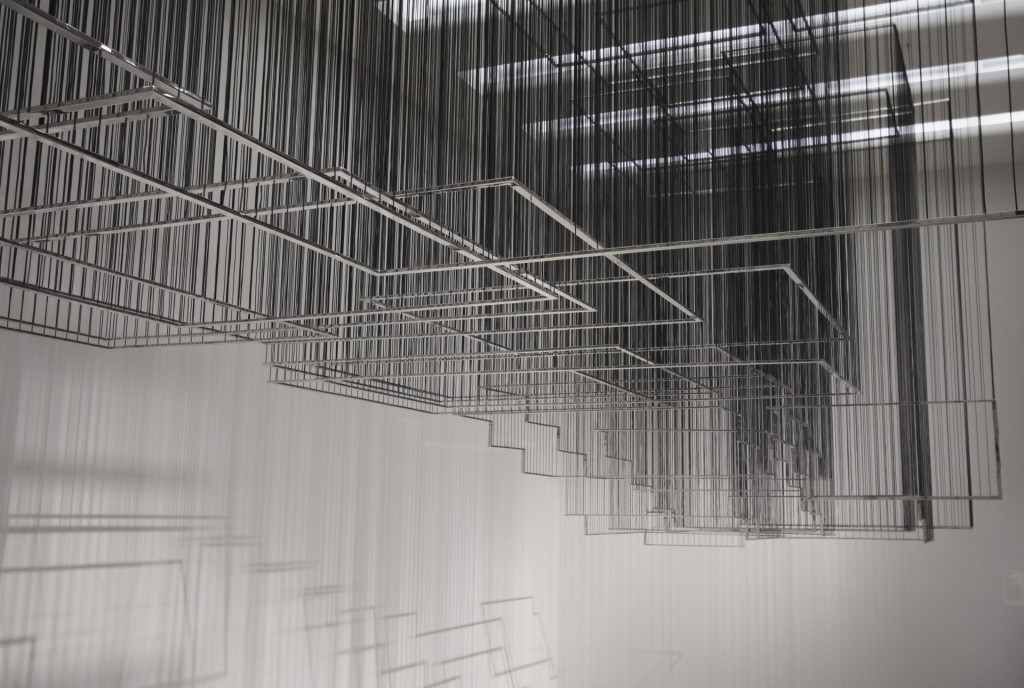 Polished steel frames hanging on black threads from the ceiling at Guggenheim Museum