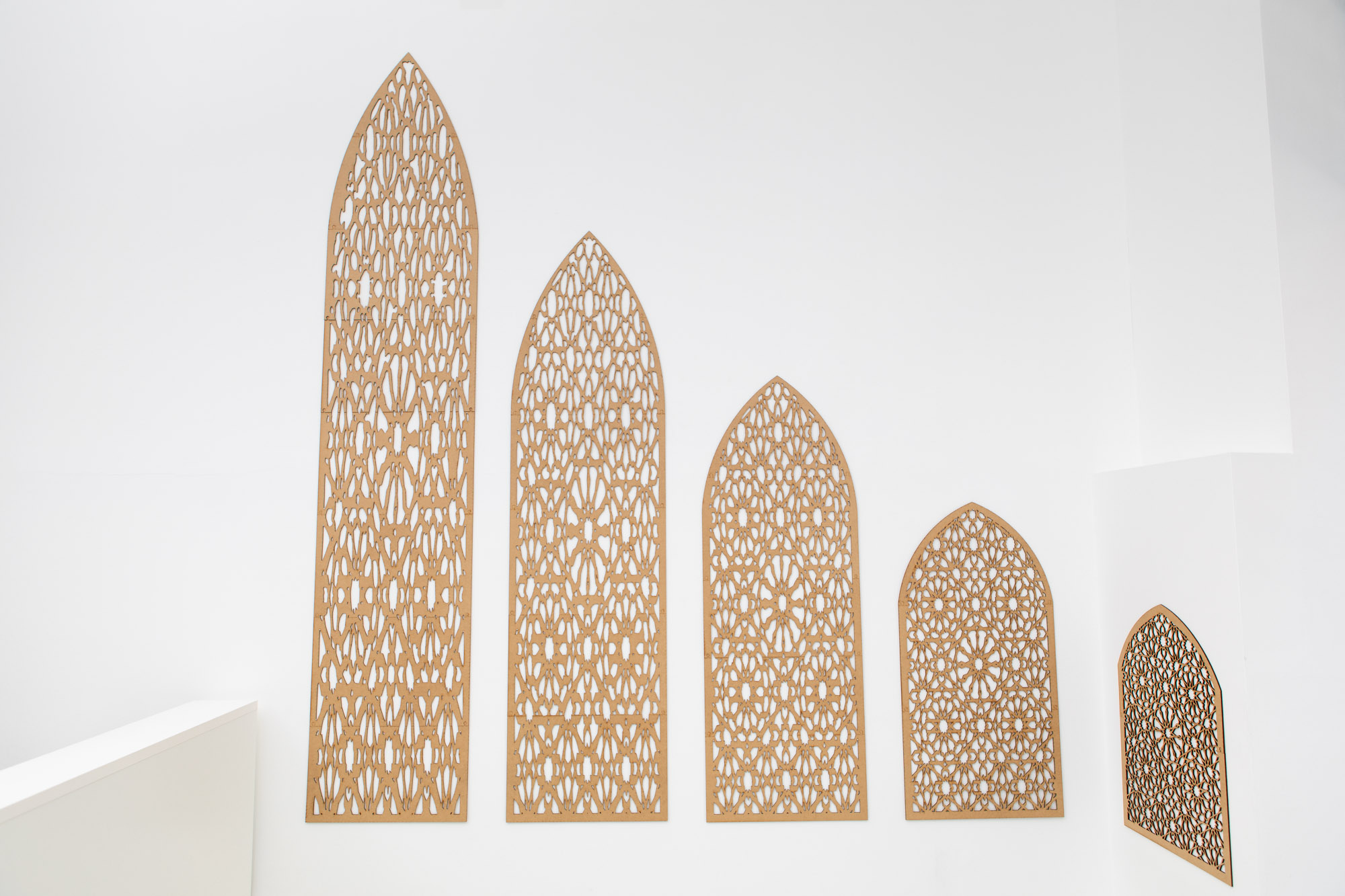 Wall installation with mdf wood cut in the shape the shadow which progressively distorts the original geometric design found in Oriental windows.