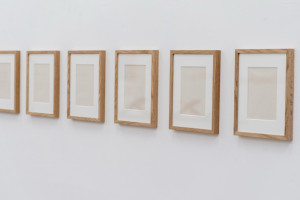 A series of eight paperworks with frames.