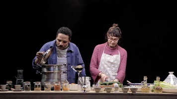 A man and a woman standing behind a kitchen island, cooking and chatting. Nadia Kaabi-Linke Life Kitchen