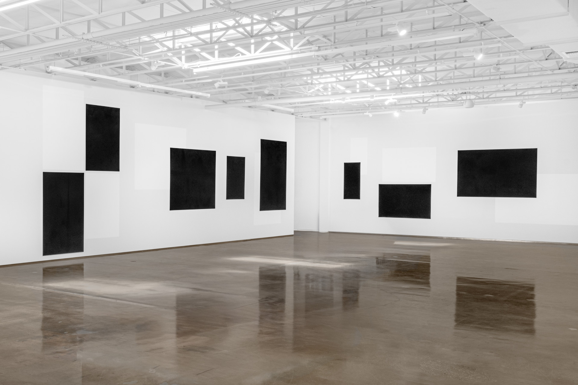 Black panels on walls in a white gallery. Nadia Kaabi-Linke, Blindstrom for Kazimir.