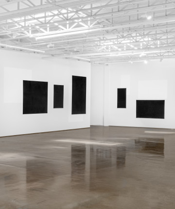 Black panels on walls in a white gallery. Nadia Kaabi-Linke, Blindstrom for Kazimir.