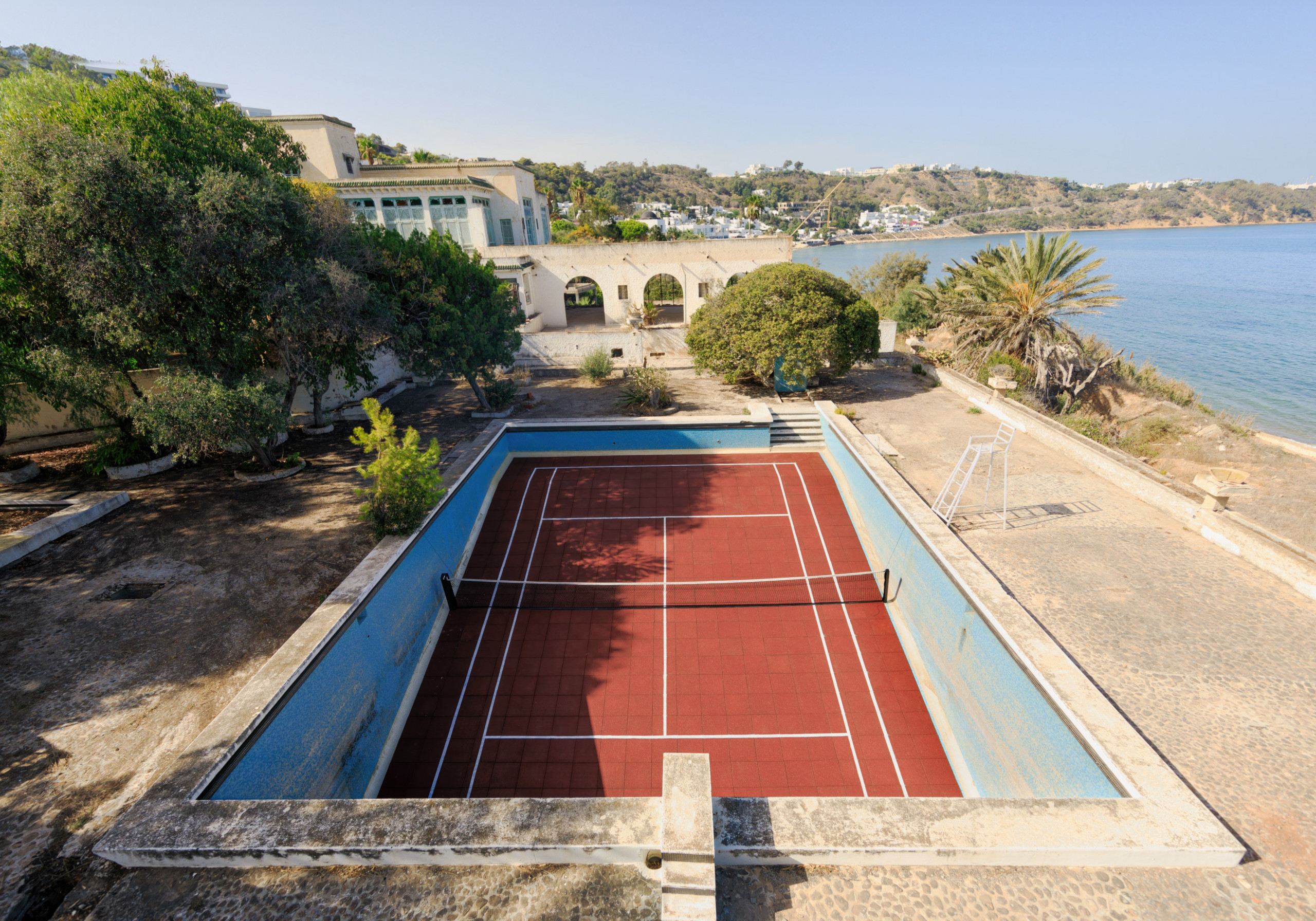 A Tennis court installed inside of a pool of an abandoned Hotel in Tunisia.