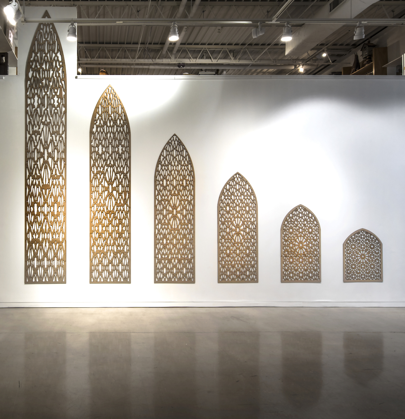 Wall installation with mdf wood cut in the shape the shadow which progressively distorts the original geometric design found in Oriental windows.