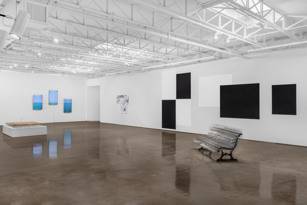 White and bright gallery with installations, canvasses and scultpures.