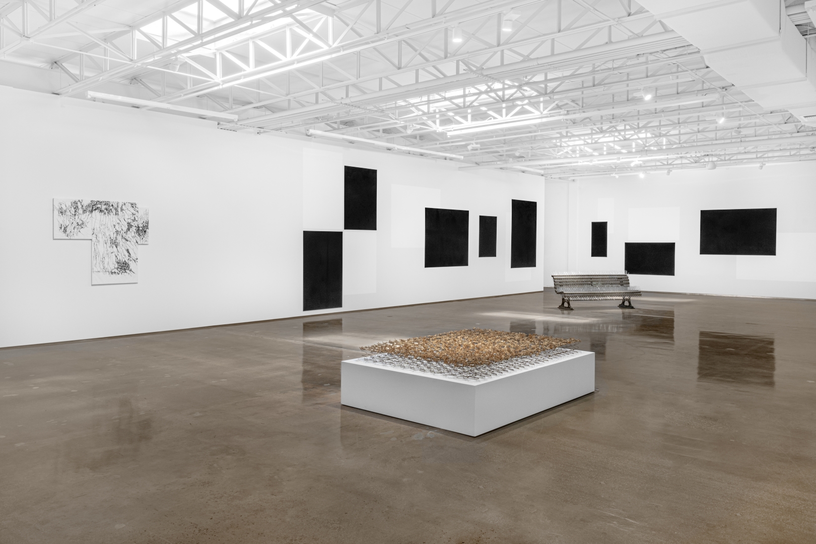 White and bright gallery with installations, canvasses and scultpures.