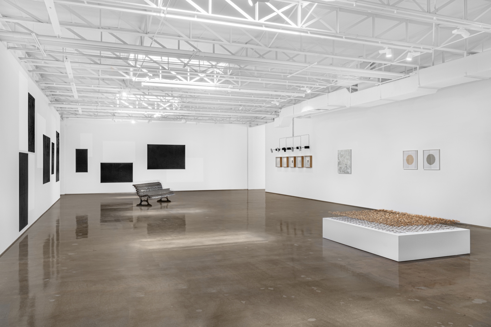 White and bright gallery with installations, canvasses and scultpures.