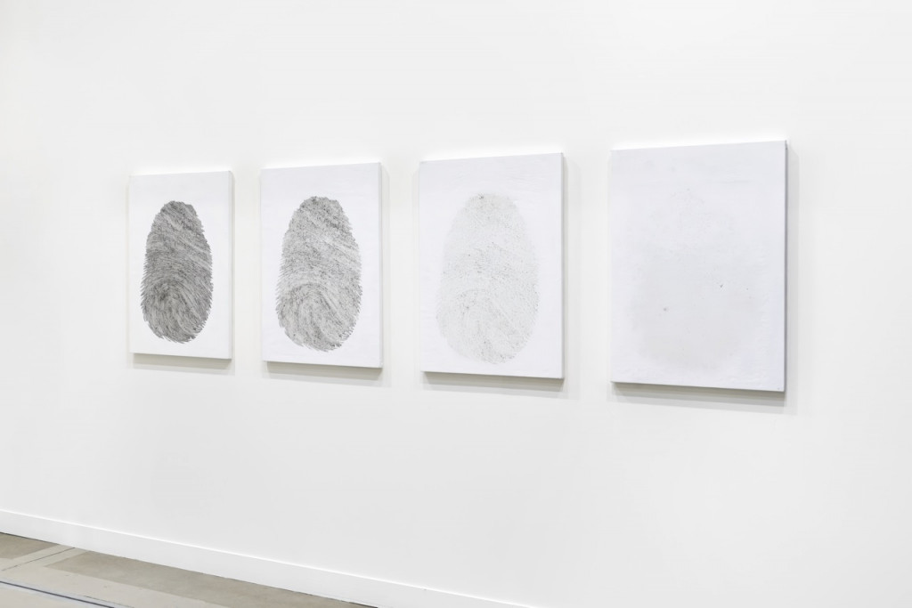 Canvasses with fading fingerprints on a wall