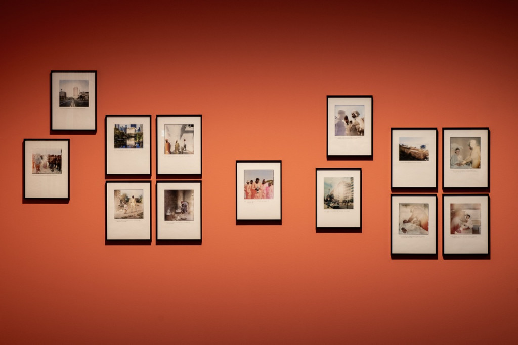 Gallery wall with installed photographs in black frames.