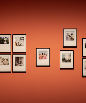 Gallery wall with installed photographs in black frames.