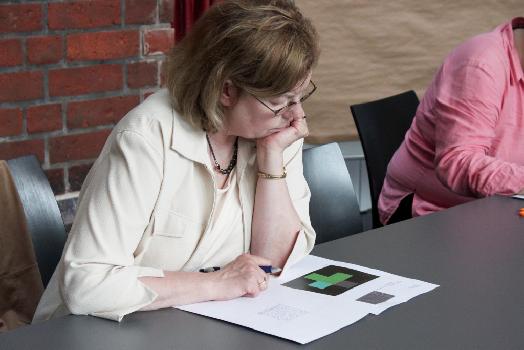 A woman is participating in a workshop with a personalised location sheet.