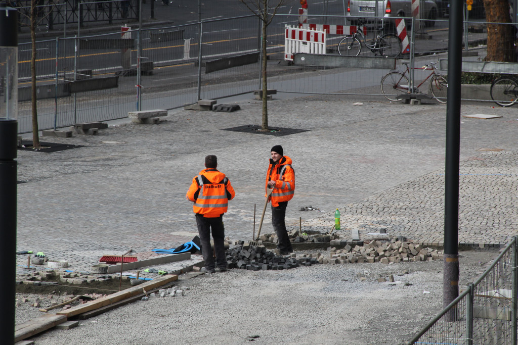 Two construction worker in conversation during the paving work.