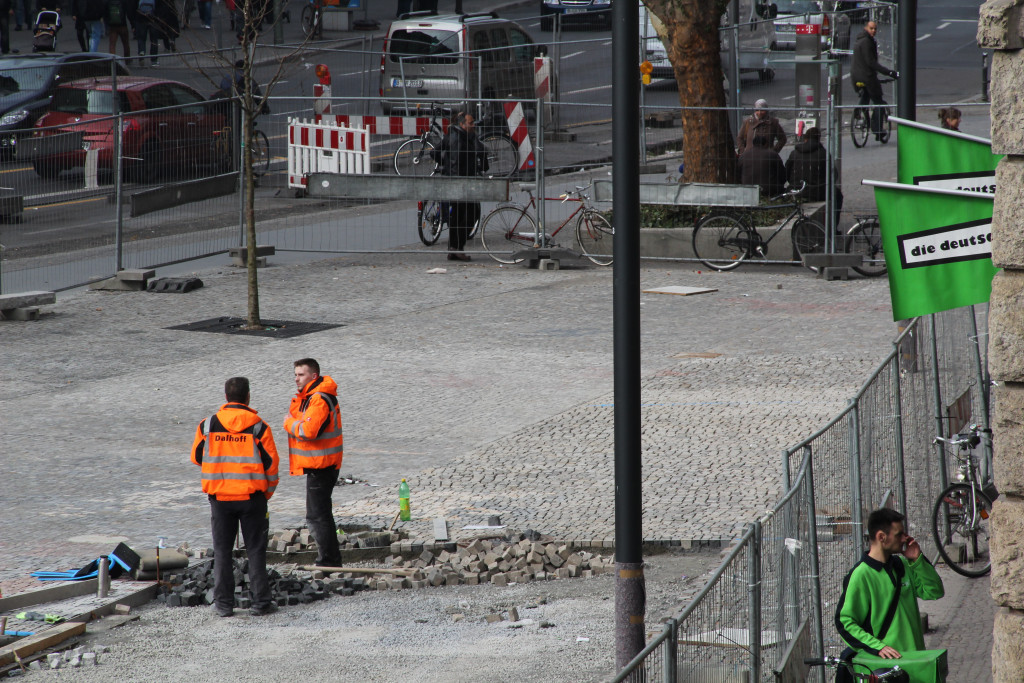Two construction worker in conversation during the paving work.
